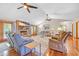 Cozy living room with a brick fireplace, ceiling fans, hardwood floors, and French doors leading to the outside at 1014 Academy Dr., Conway, SC 29526