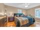 Comfortable main bedroom with hardwood floors, ceiling fan and chair by the window at 1014 Academy Dr., Conway, SC 29526