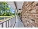 Long brick porch with chairs and ceiling fans overlooking the yard at 1014 Academy Dr., Conway, SC 29526
