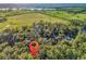 A vast landscape of fields and trees with a small group of houses nestled in between at 1033 Tuckers Rd., Pawleys Island, SC 29585