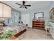 Comfortable bedroom with soft blue walls, ceiling fan, and large dresser at 1033 Tuckers Rd., Pawleys Island, SC 29585