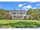Two-story home with traditional columns and landscaped yard at 1033 Tuckers Rd., Pawleys Island, SC 29585