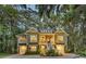 Charming two-story home featuring double garages, mature landscaping, and beautiful surrounding trees at 1033 Tuckers Rd., Pawleys Island, SC 29585