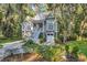 Charming two-story home with a well-manicured lawn and lush landscaping at 1033 Tuckers Rd., Pawleys Island, SC 29585