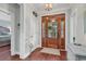 Bright foyer with hardwood floors, white trim, and a wood door with glass panels at 1033 Tuckers Rd., Pawleys Island, SC 29585