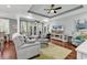 Comfortable living room with a tray ceiling, hardwood floors, and a built-in entertainment center at 1033 Tuckers Rd., Pawleys Island, SC 29585