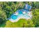 Aerial view of a large community pool surrounded by trees and lounge chairs at 1033 Tuckers Rd., Pawleys Island, SC 29585