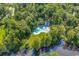 Aerial view of the community pool with green landscaping and views of a nearby river at 1033 Tuckers Rd., Pawleys Island, SC 29585