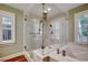 Bathroom featuring a glass-enclosed shower and tub with marble-look tile and wood-look flooring at 107 Azalea Dr., Conway, SC 29526