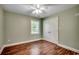 Cozy bedroom with a ceiling fan, hardwood floors, and plenty of natural light at 107 Azalea Dr., Conway, SC 29526