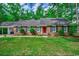 Charming single-story brick home with black shutters, a red front door, and a well-maintained lawn at 107 Azalea Dr., Conway, SC 29526