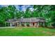 Charming brick ranch home with a well-manicured lawn and mature trees at 107 Azalea Dr., Conway, SC 29526