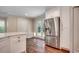 Kitchen area featuring a stainless steel refrigerator, hardwood floors, and white cabinets at 107 Azalea Dr., Conway, SC 29526