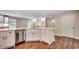 Bright kitchen featuring white cabinets, stainless steel appliances, hardwood floors, and stone countertops at 107 Azalea Dr., Conway, SC 29526
