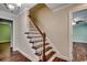 Staircase with wooden steps, white risers, and views into adjacent rooms at 107 Azalea Dr., Conway, SC 29526
