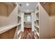 Spacious walk-in closet with custom shelving and wood-look flooring provides ample storage and organization at 107 Azalea Dr., Conway, SC 29526