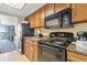 Efficient kitchen area features black appliances, granite counters and an opening to the living area at 1105 S Ocean Blvd. # 1024, Myrtle Beach, SC 29572