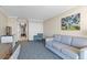 Comfortable living room featuring a sofa, chair, TV, and a glimpse of a hallway at 1105 S Ocean Blvd. # 1024, Myrtle Beach, SC 29572