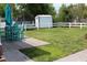 Spacious backyard with a deck, patio furniture, shed, and a white picket fence at 1145 Forest Dr., North Myrtle Beach, SC 29582