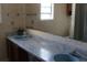 Outdated bathroom featuring a double sink vanity with blue sinks and patterned wallpaper at 1145 Forest Dr., North Myrtle Beach, SC 29582
