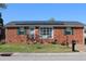 Charming brick home featuring solar panels, a well-maintained lawn and a pleasant front yard at 1145 Forest Dr., North Myrtle Beach, SC 29582
