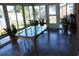 Enclosed sunroom with glass table, tile flooring, plants, and access to the backyard at 1145 Forest Dr., North Myrtle Beach, SC 29582