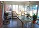 Bright sunroom with glass table, wicker chairs, brick walls, and large windows overlooking the backyard at 1145 Forest Dr., North Myrtle Beach, SC 29582