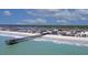 Coastal aerial view featuring a long wooden pier, beach and residential community at 126 N Waccamaw Dr. # 101, Garden City Beach, SC 29576