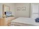 Bedroom with a dresser, television, and cozy queen bed and nautical seashell accents at 126 N Waccamaw Dr. # 101, Garden City Beach, SC 29576