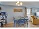 Cozy dining area with blue table, wooden chairs, and beach-themed artwork at 126 N Waccamaw Dr. # 101, Garden City Beach, SC 29576