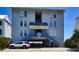 Beach condo building featuring covered parking and staircase access at 126 N Waccamaw Dr. # 101, Garden City Beach, SC 29576