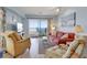 Bright living room with comfortable seating and sliding glass doors leading to a balcony with ocean views at 126 N Waccamaw Dr. # 101, Garden City Beach, SC 29576