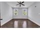 Bright, neutral bedroom with hardwood floors, two windows, and ceiling fan at 130 Hagar Brown Rd., Murrells Inlet, SC 29576