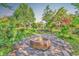 Outdoor fire pit on stone patio with mature landscaping at 130 Hagar Brown Rd., Murrells Inlet, SC 29576