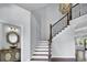 Elegant foyer with staircase and modern chandelier at 130 Hagar Brown Rd., Murrells Inlet, SC 29576