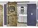 Laundry room features white washer and dryer set with decorative tiled wall and sliding barn door at 130 Hagar Brown Rd., Murrells Inlet, SC 29576