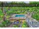 Swimming pool and pool house in a private backyard with lush landscaping at 130 Hagar Brown Rd., Murrells Inlet, SC 29576