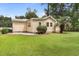 The backyard shows the rear of the home and nice green grass at 131 Oak Log Lake Rd., Conway, SC 29526
