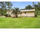 The backyard shows the rear of the home and nice green grass at 131 Oak Log Lake Rd., Conway, SC 29526