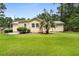 The backyard shows the rear of the home and nice green grass at 131 Oak Log Lake Rd., Conway, SC 29526