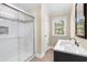 Updated bathroom boasts a glass-enclosed shower and stylish vanity with natural light at 131 Oak Log Lake Rd., Conway, SC 29526