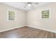 Comfortable bedroom with wood floors and natural light from large windows at 131 Oak Log Lake Rd., Conway, SC 29526
