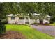 Charming house with a quaint front porch, mature landscaping, and a circular driveway at 131 Oak Log Lake Rd., Conway, SC 29526
