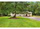 Lovely home with manicured lawn, circular driveway, and a charming front porch at 131 Oak Log Lake Rd., Conway, SC 29526