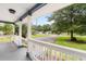 Covered front porch provides a view of the street and landscaped front yard at 131 Oak Log Lake Rd., Conway, SC 29526