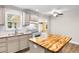 Well-lit kitchen with an island, granite countertops, white appliances, and access to an adjoining room at 131 Oak Log Lake Rd., Conway, SC 29526