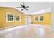 Bright living room with yellow walls, tile flooring, and lots of natural light from the windows at 131 Oak Log Lake Rd., Conway, SC 29526