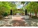 Welcoming entrance to the Riverwalk, featuring a brick pathway, benches, and lush greenery at 131 Oak Log Lake Rd., Conway, SC 29526