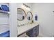 Bright bathroom featuring a modern vanity with round mirrors and ample counter space for toiletries at 1356 Glenns Bay Rd. # 208M, Surfside Beach, SC 29575