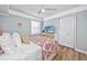 Bedroom featuring bright paisley bedding, ceiling fan and television on white dresser at 1356 Glenns Bay Rd. # 208M, Surfside Beach, SC 29575